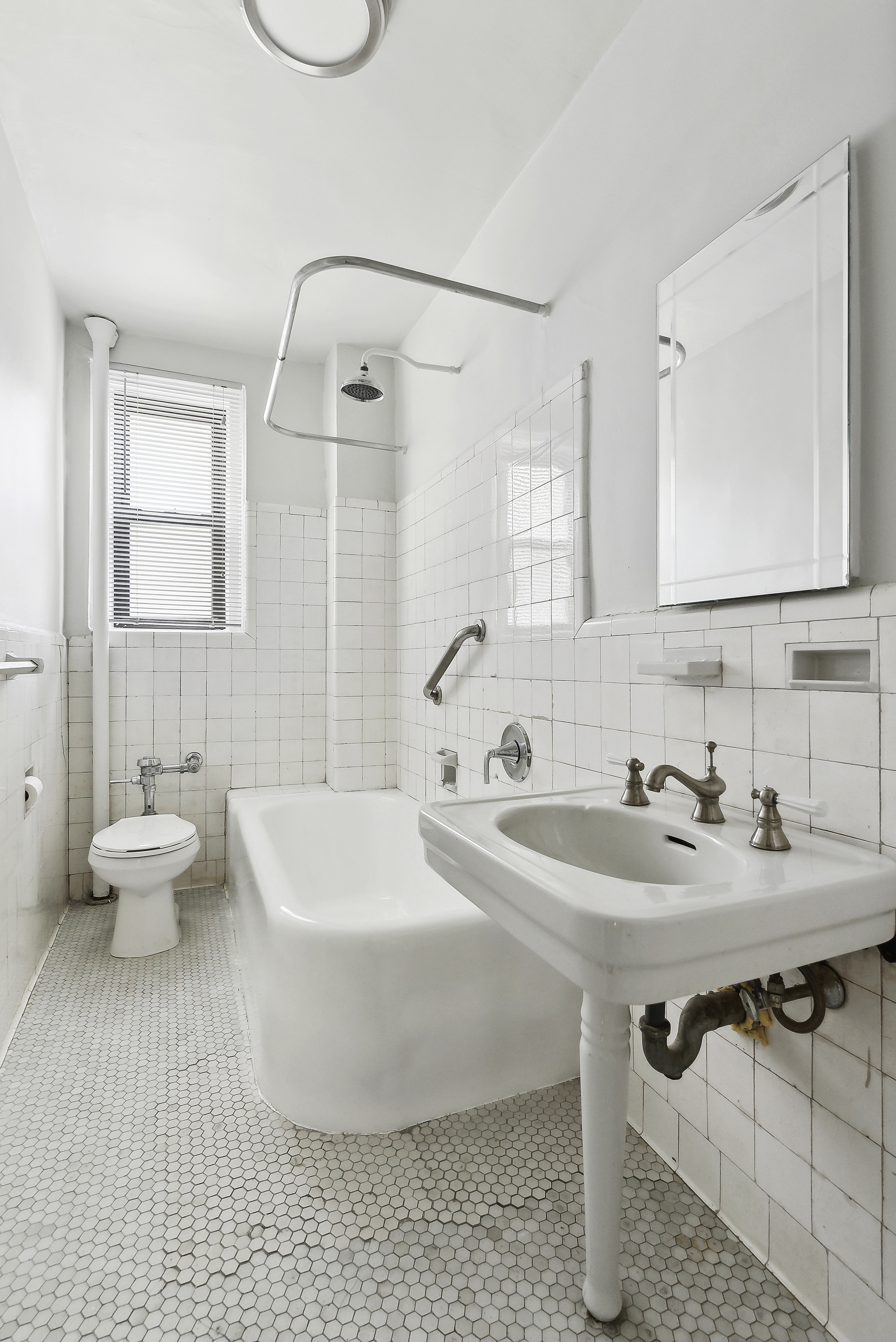 321 East 54th Street, Unit 9B Manhattan, NY 10022 - Photo 8 of 13 a bathroom with a sink and a mirror