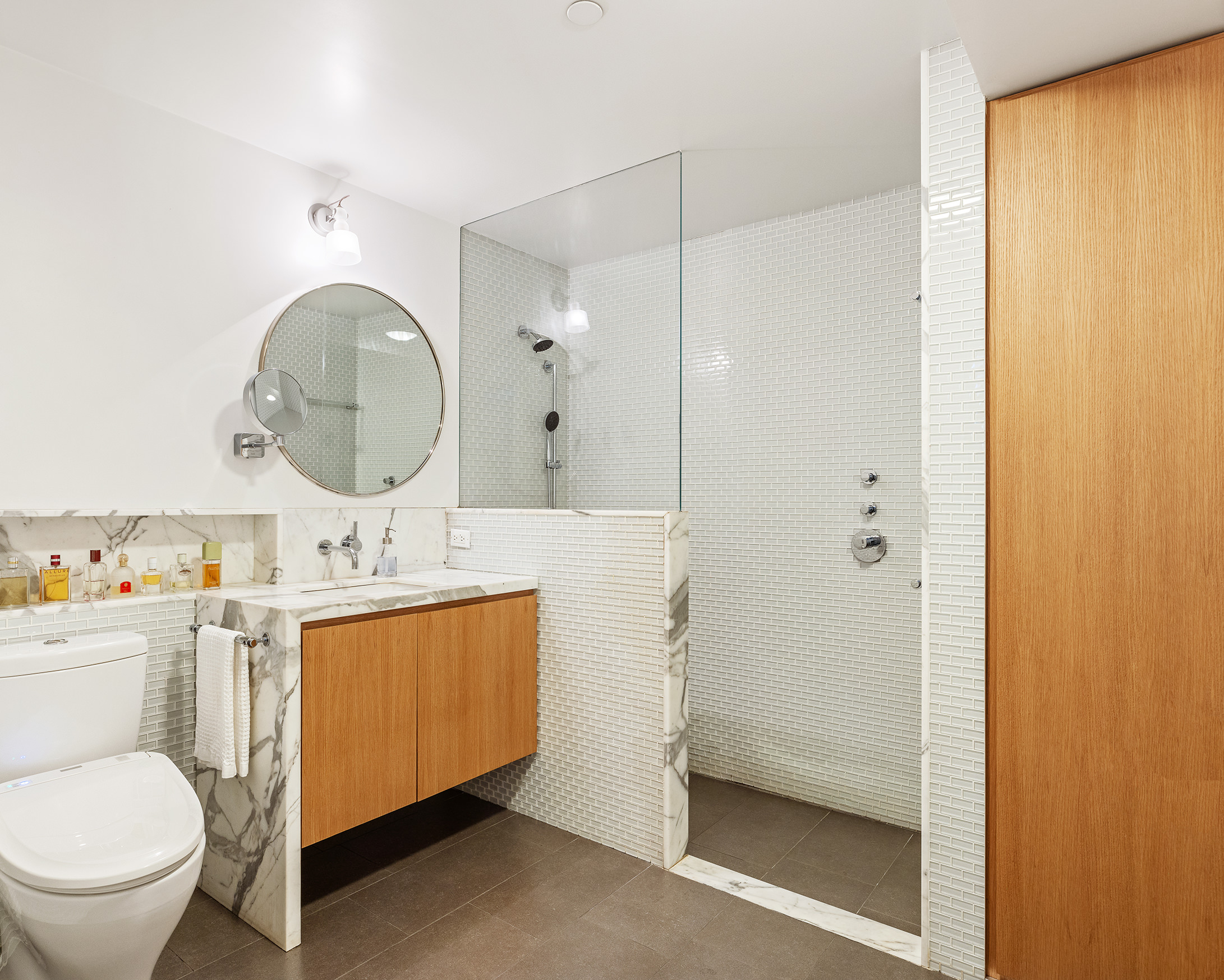 71 Ludlow Street, Unit 4B Manhattan, NY 10002 - Photo 9 of 15 a bathroom with a toilet a sink and a mirror