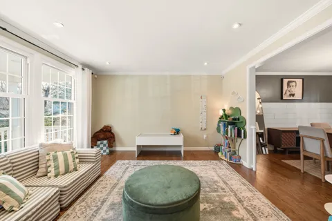 a bedroom with furniture and a large window