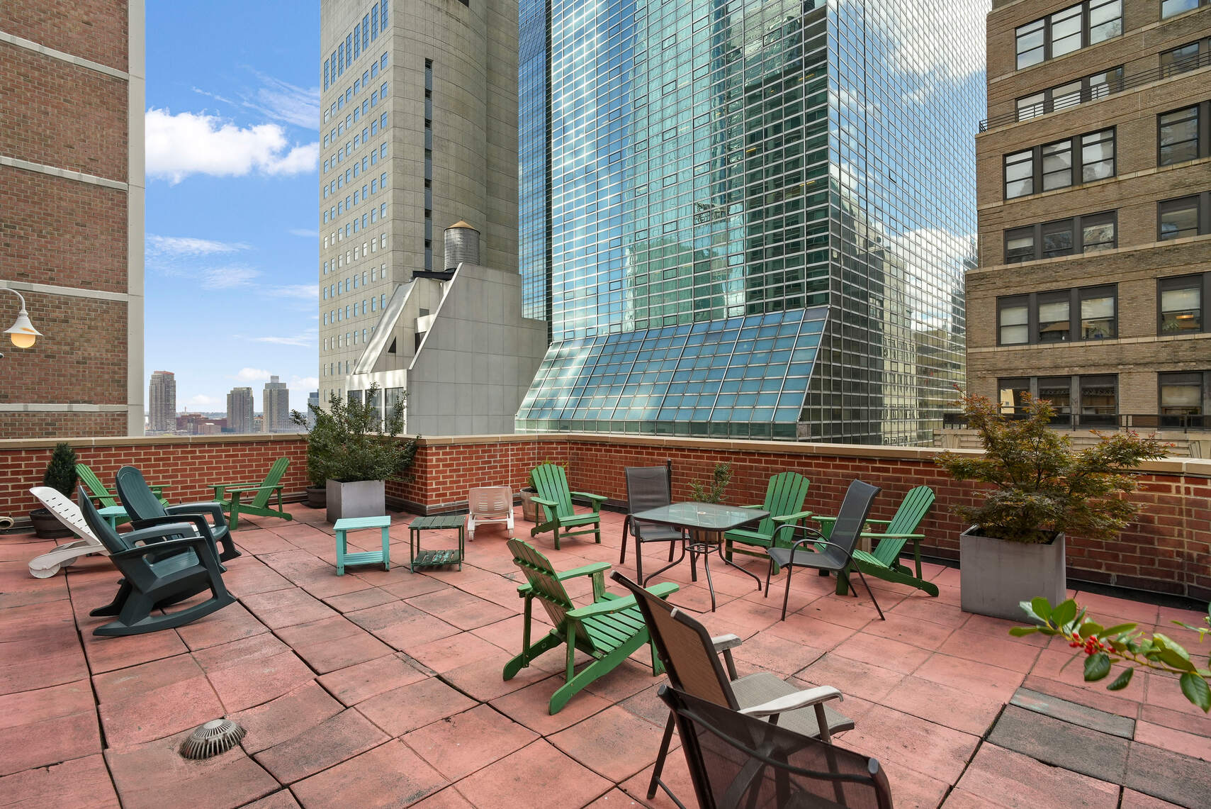 321 East 45th Street, Unit 1F Manhattan, NY 10017 - Photo 12 of 14 a backyard of a house with barbeque oven table and chairs