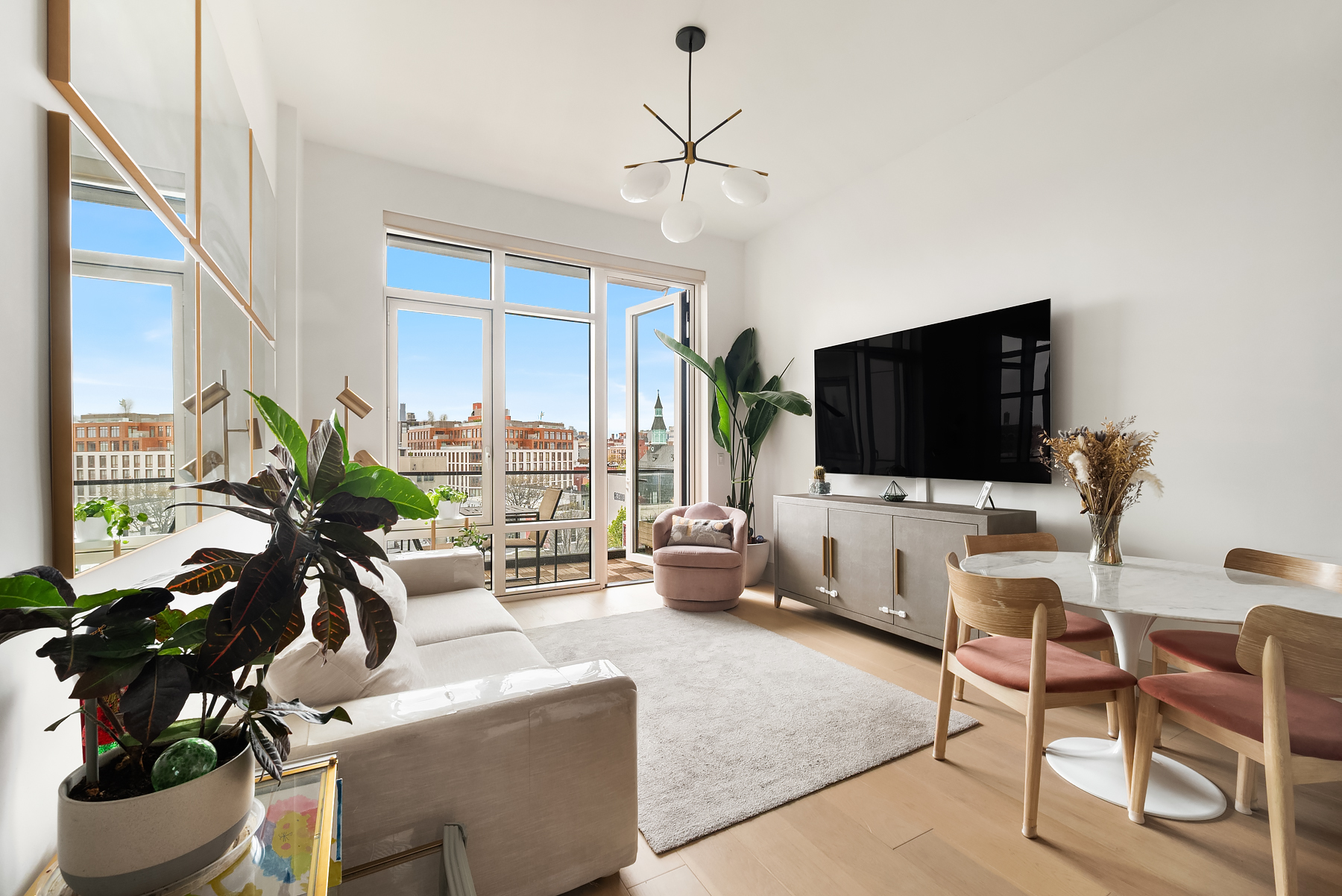 308 North 7th Street, Unit 7E Brooklyn, NY 11211 - Photo 1 of 13 a living room with furniture and a flat screen tv