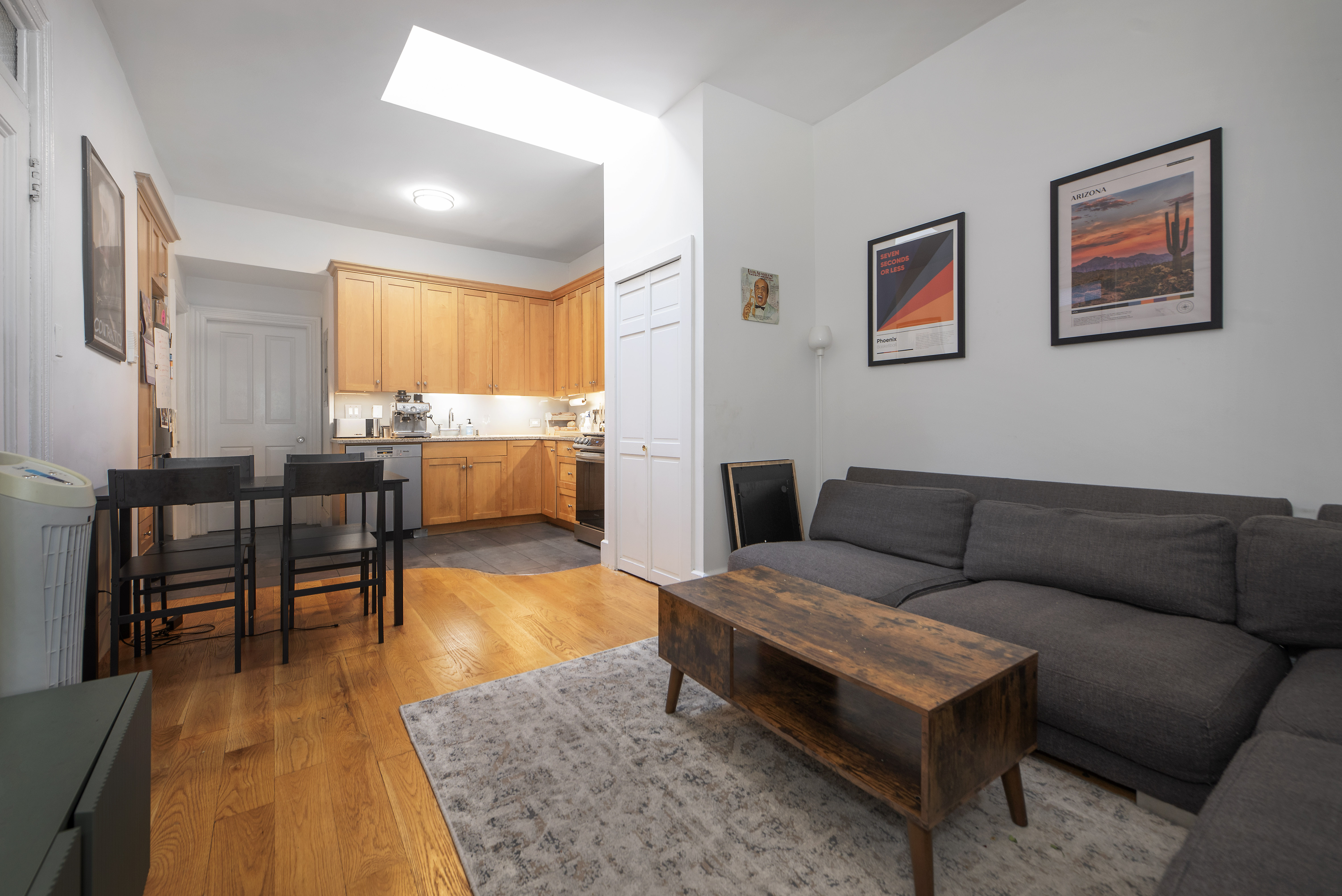249 East Houston Street, Unit 4 Manhattan, NY 10002 - Photo 2 of 10 a living room with furniture and a wooden floor
