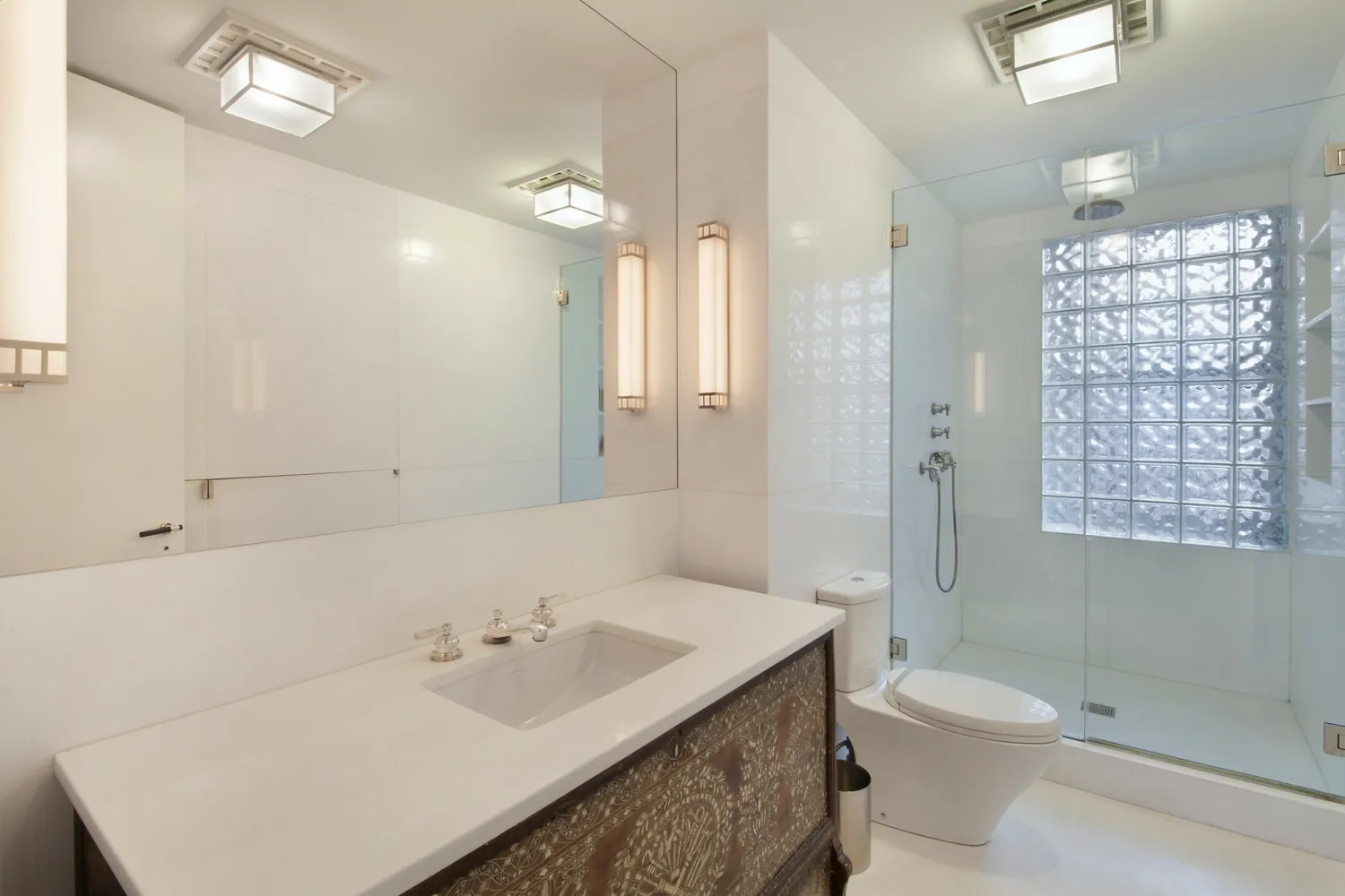 a bathroom with a sink a toilet and shower