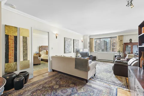 a living room with furniture large windows and a flat screen tv