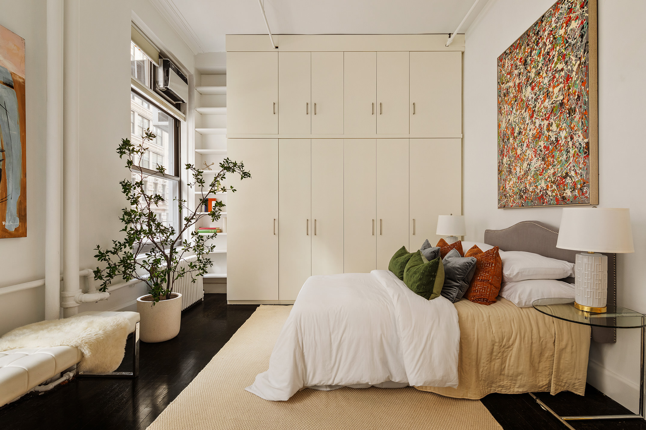 142 5th Avenue, Unit 2 Manhattan, NY 10011 - Photo 11 of 18 a bedroom with a bed and a potted plant