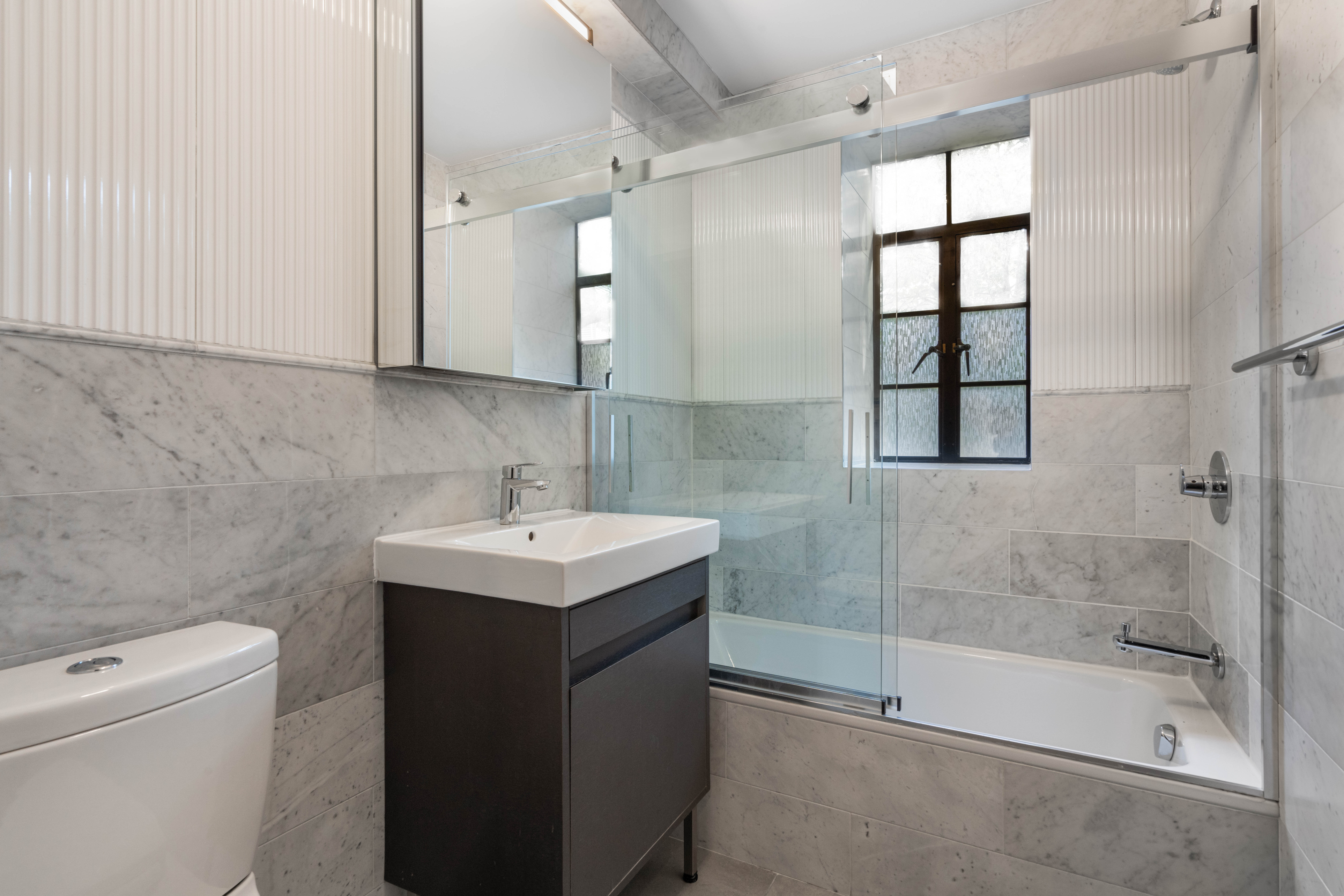 25 Monroe Place, Unit 6F Brooklyn, NY 11201 - Photo 5 of 7 a bathroom with a sink toilet and shower