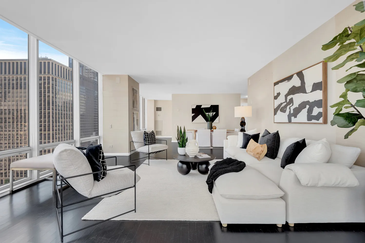 a living room with furniture and large windows