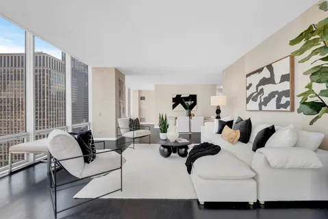 a living room with furniture and large windows