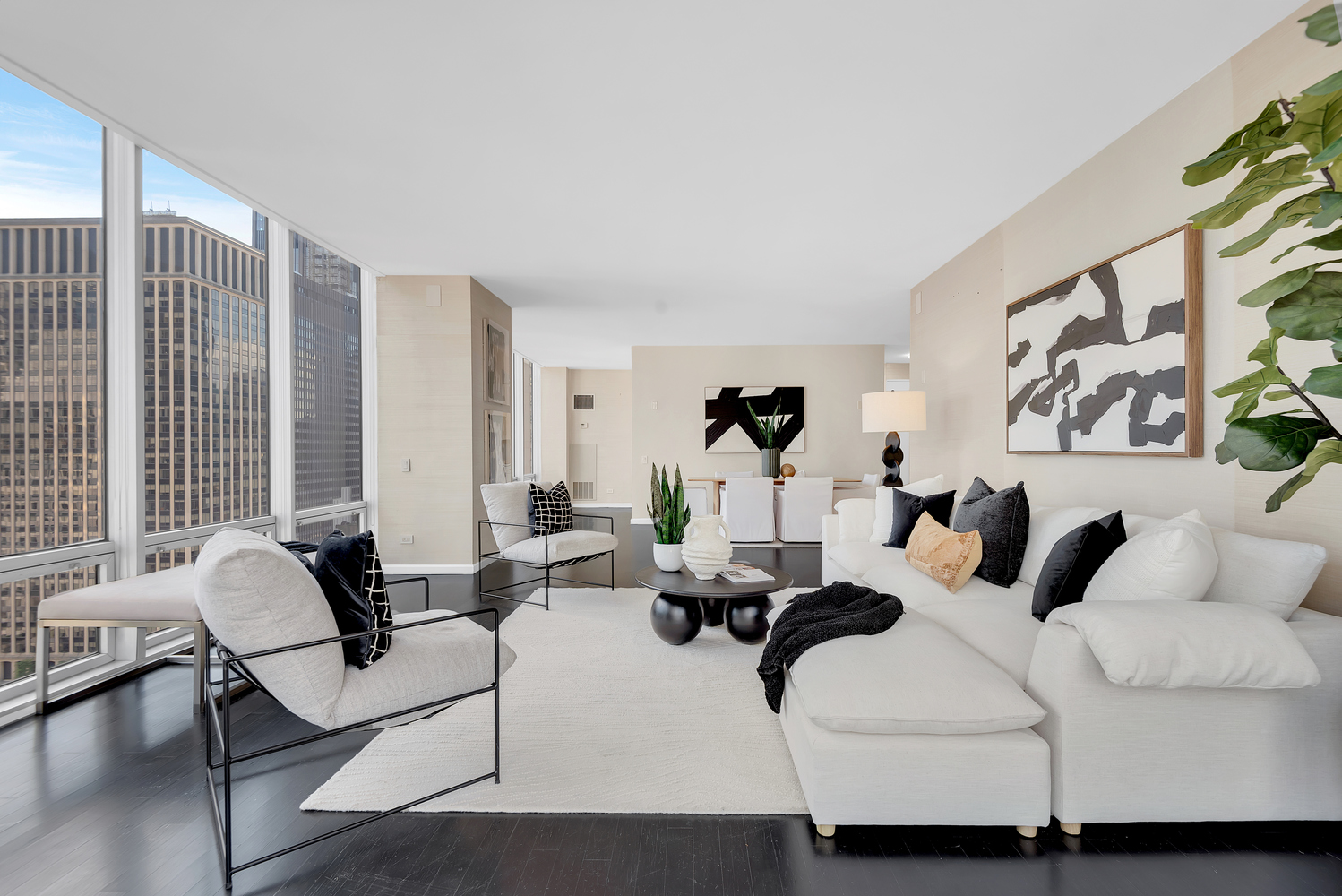 641 5th Avenue, Unit 26D Manhattan, NY 10022 - Photo 2 of 13 a living room with furniture and large windows