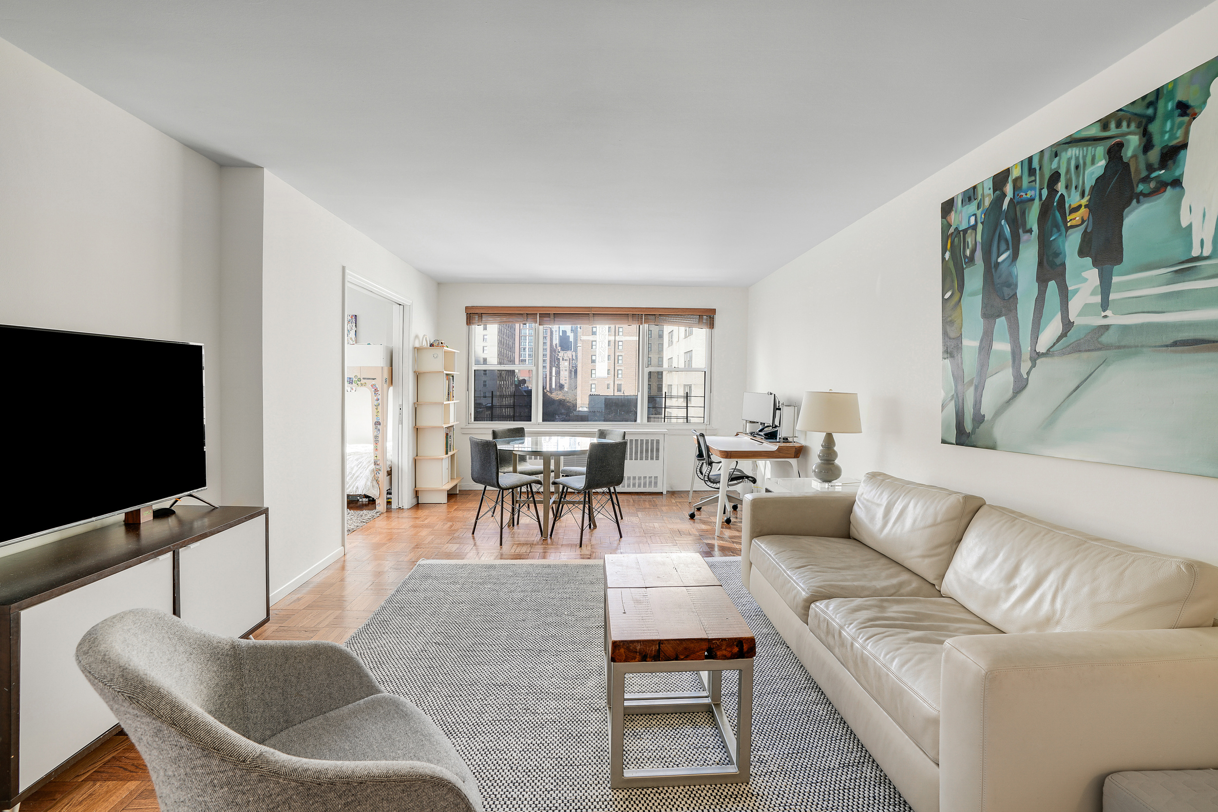 201 East 37th Street, Unit 11D Manhattan, NY 10016 - Photo 2 of 11 a living room with furniture and a flat screen tv