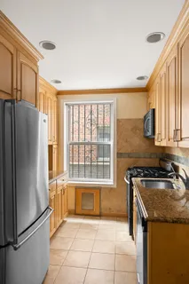 a kitchen with a refrigerator a sink and cabinets