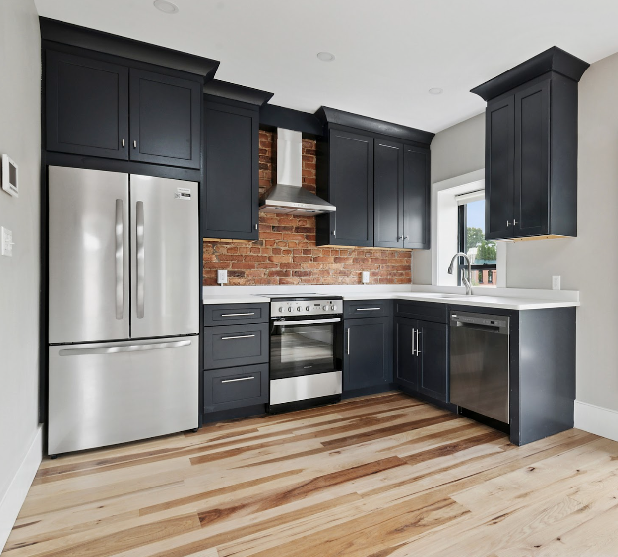 264 Stuyvesant Avenue, Unit 1 Brooklyn, NY 11221 - Photo 4 of 9 a kitchen with stainless steel appliances a refrigerator stove and sink