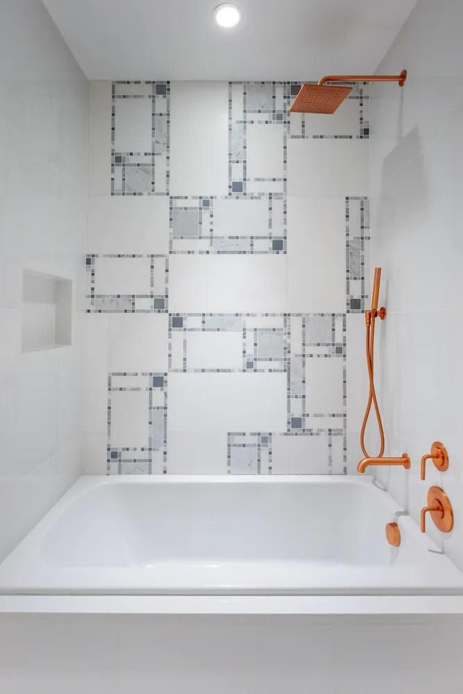 a bathroom with a bathtub and next to a window