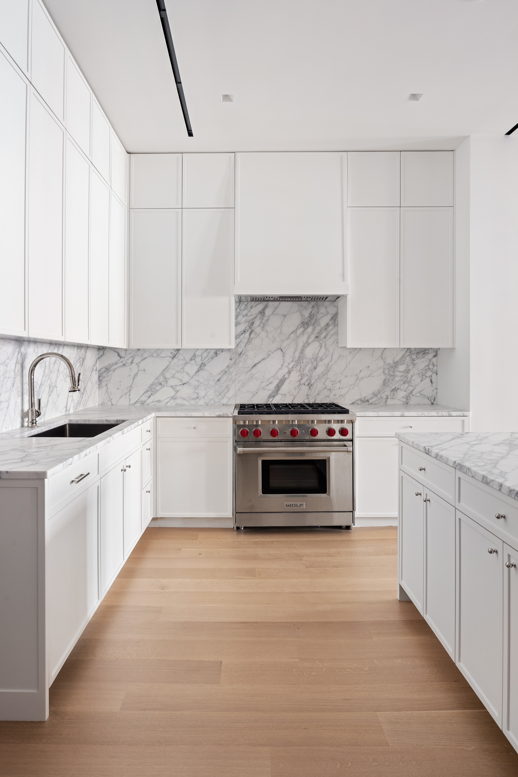 243 West Broadway, Unit 3 Manhattan, NY 10013 - Photo 11 of 25 a kitchen with granite countertop a stove sink and cabinets