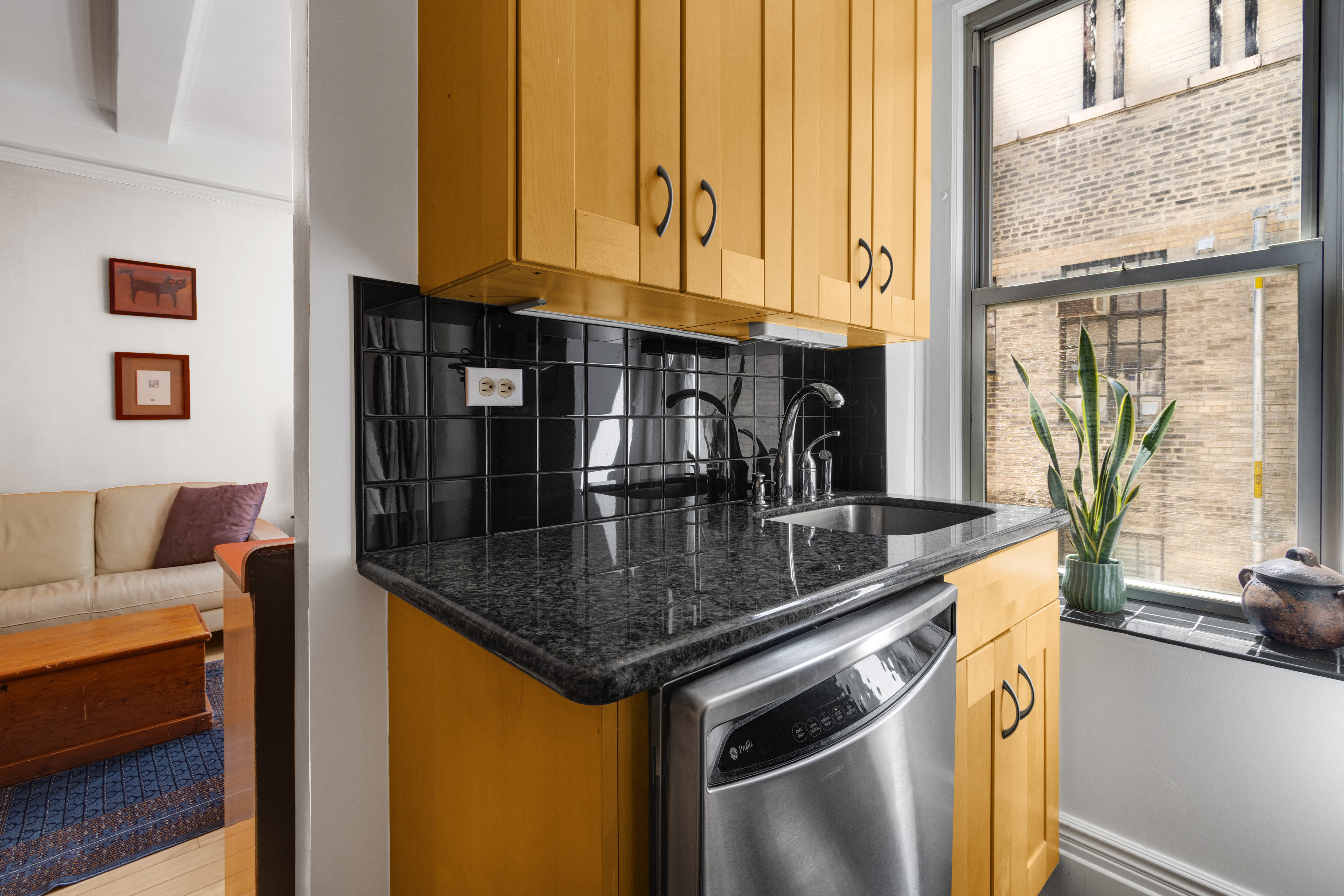 588 West End Avenue, Unit 16D Manhattan, NY 10024 - Photo 4 of 12 a kitchen with stainless steel appliances granite countertop a sink and a window