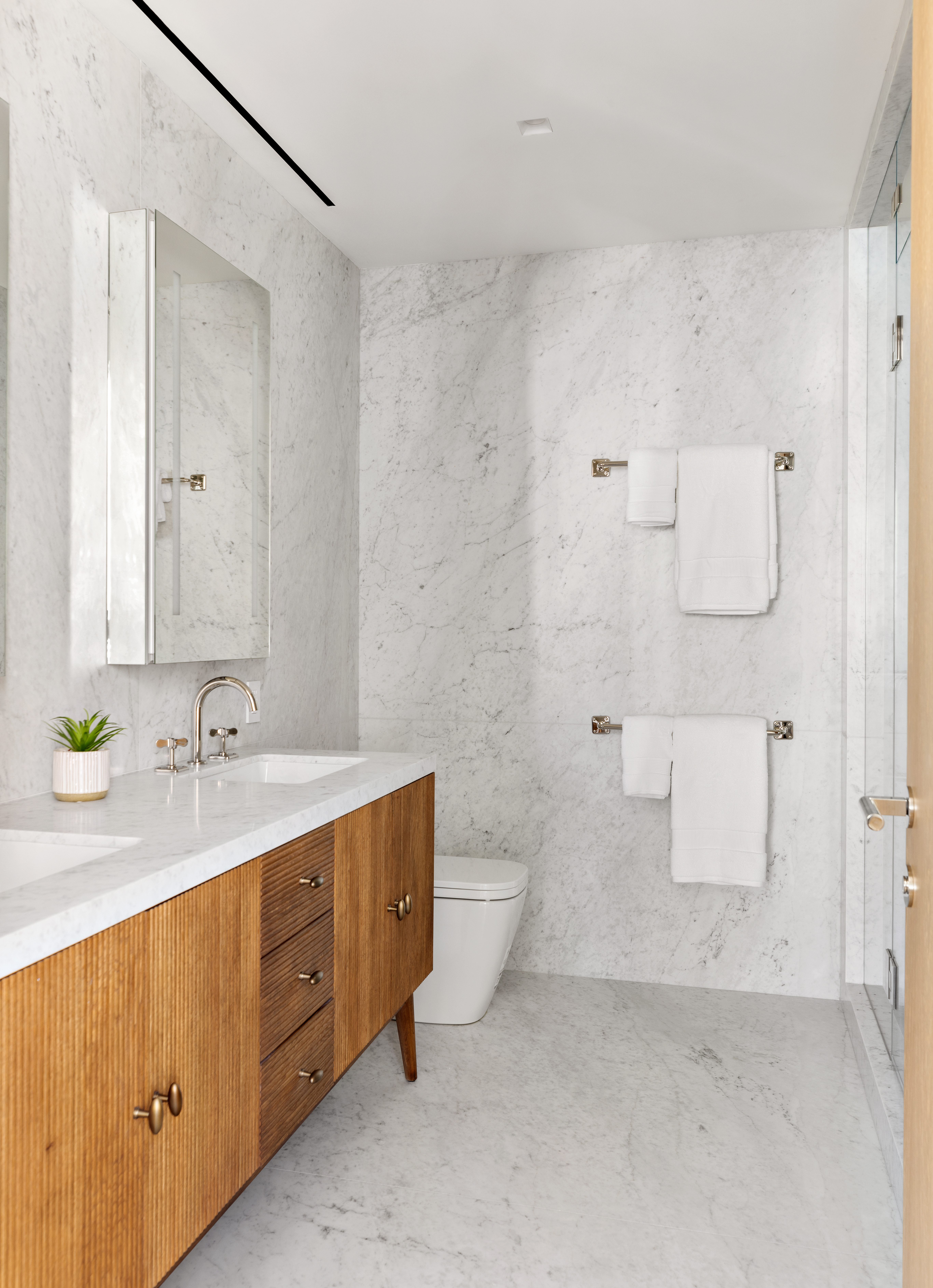 120 East 29th Street, Unit PHB Manhattan, NY 10016 - Photo 7 of 10 a bathroom with a double vanity sink toilet and mirror