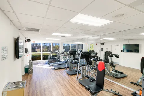 a living room with lots of furniture and wooden floor