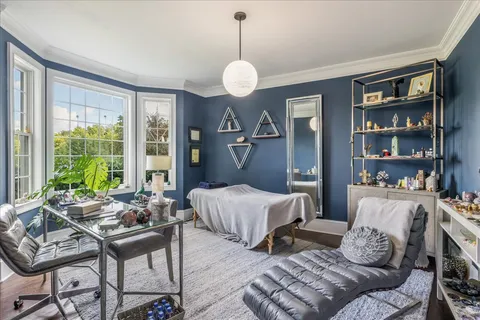 a bedroom with a bed and a chandelier