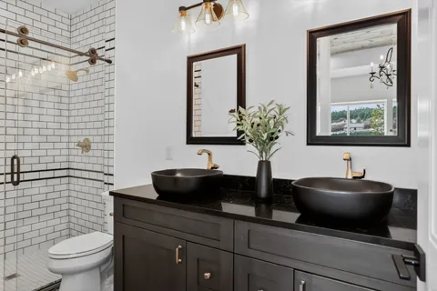 a bathroom with a sink a toilet and mirror