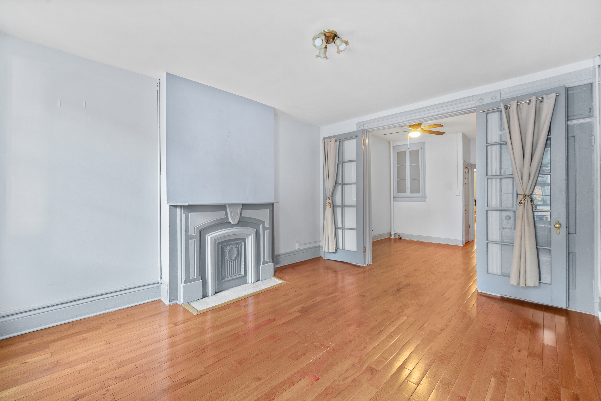 1663 1st Avenue, Unit 2S Manhattan, NY 10028 - Photo 3 of 6 a view of empty room with wooden floor and fireplace