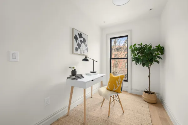 a view of a workspace with furniture and a potted plant