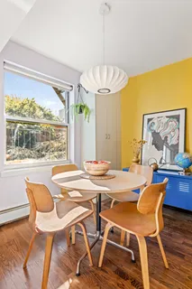 a view of a dining room with furniture wooden floor and a chandelier