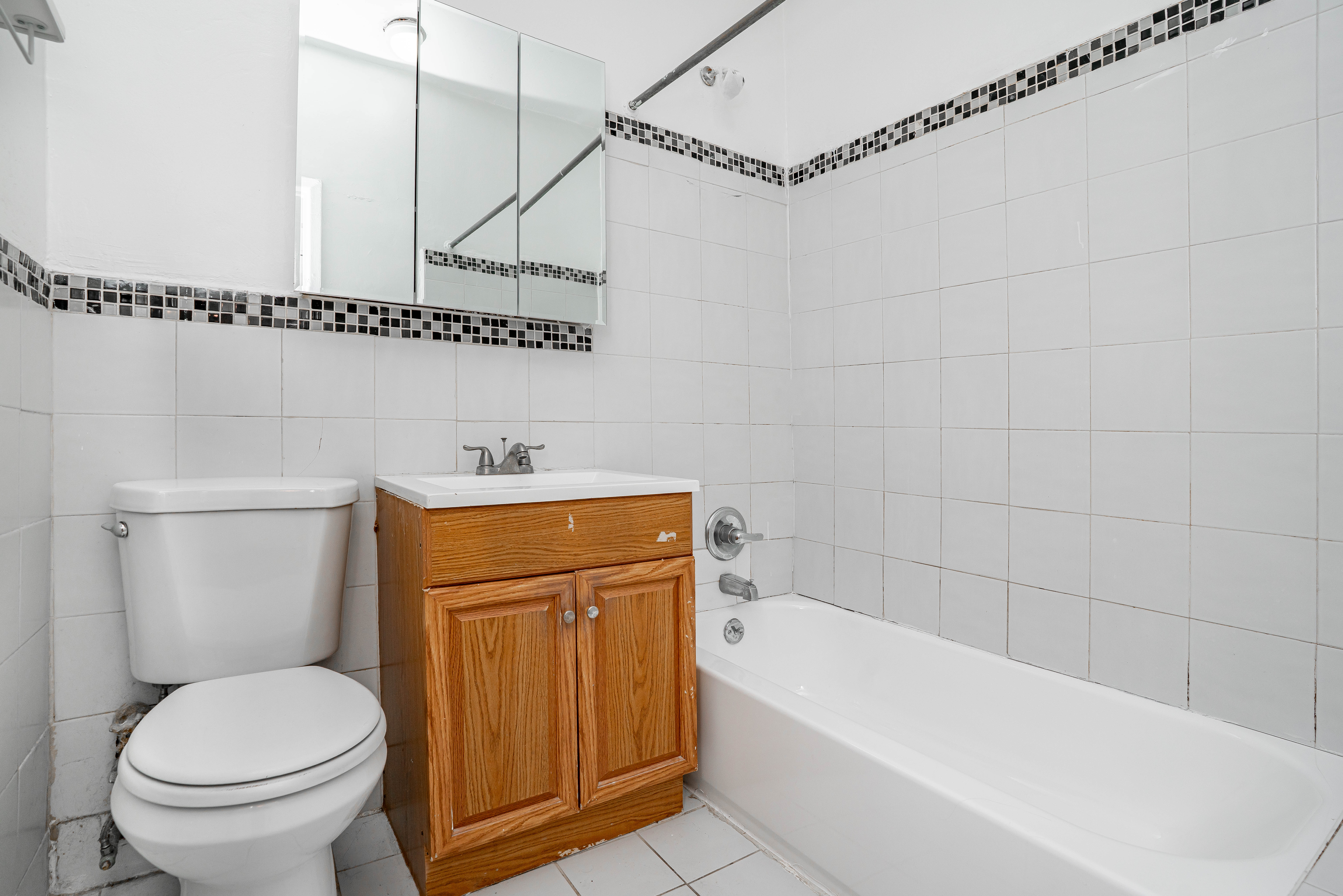 27-15 24th Avenue, Unit 2 Queens, NY 11105 - Photo 4 of 10 a bathroom with a sink a toilet and shower