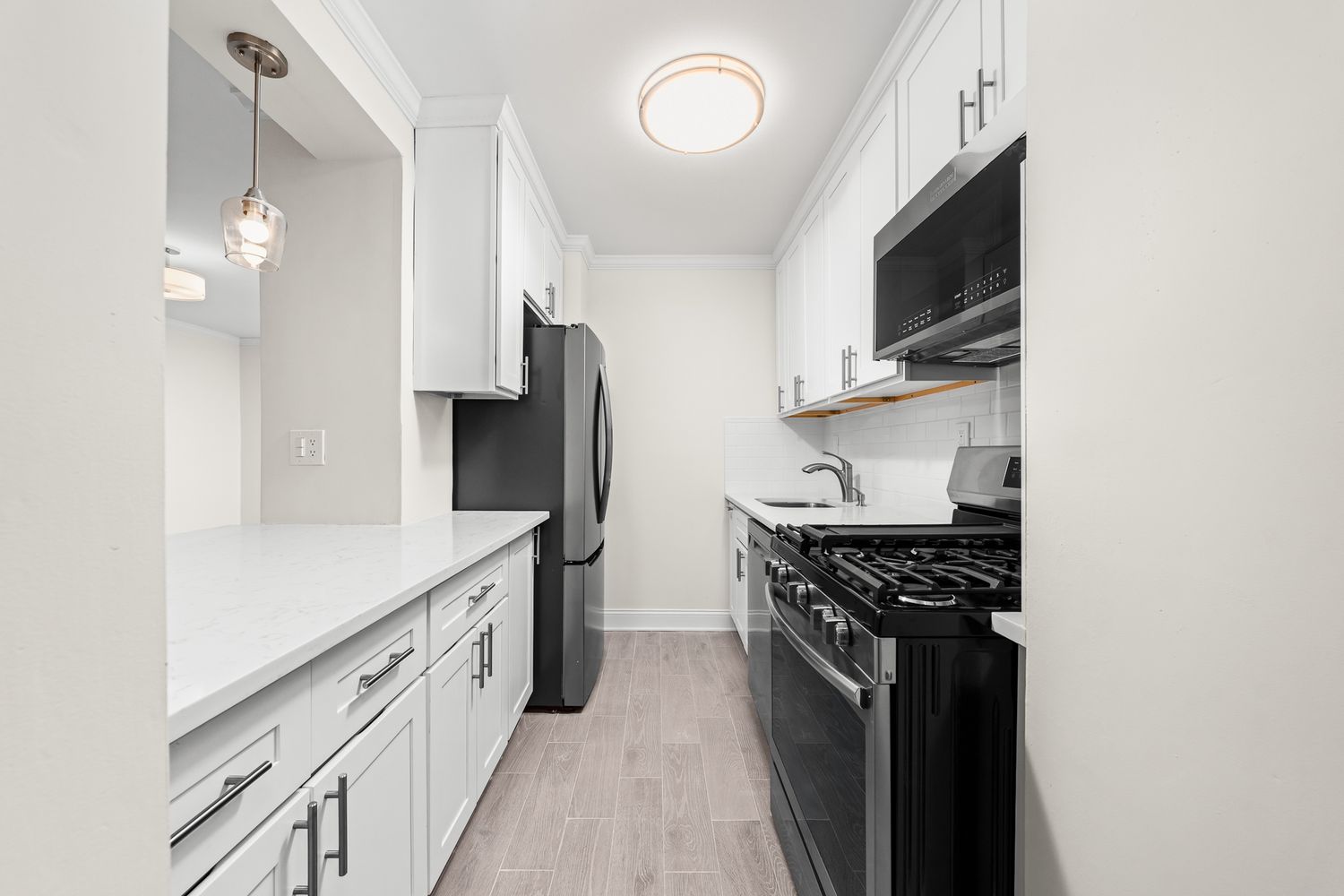 a kitchen with stainless steel appliances a sink stove and refrigerator