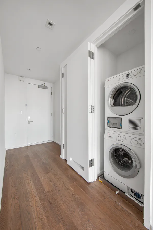 a view of a storage & utility room with a washer dryer