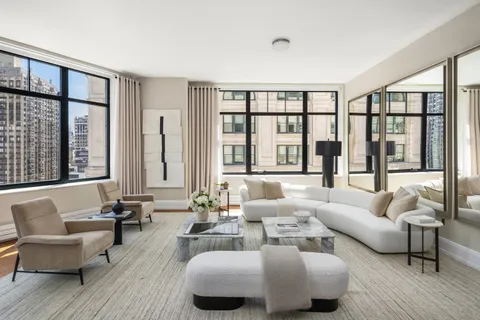 a living room with furniture and a large window with outer view