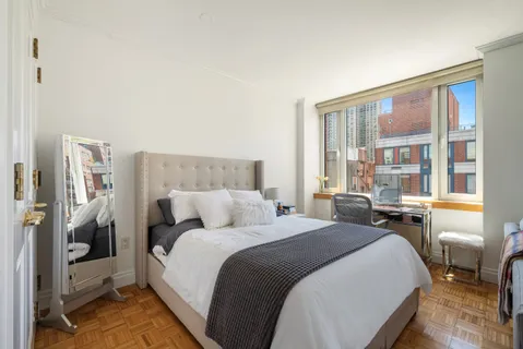 a bedroom with a bed and a large window