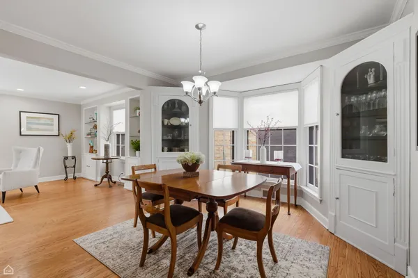 a dining room with furniture window and wooden floor