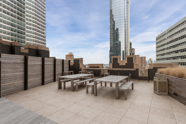 100 Barclay Street, Unit 13G Manhattan, NY 10007 - Photo 13 of 26 a view of a terrace with furniture and city view