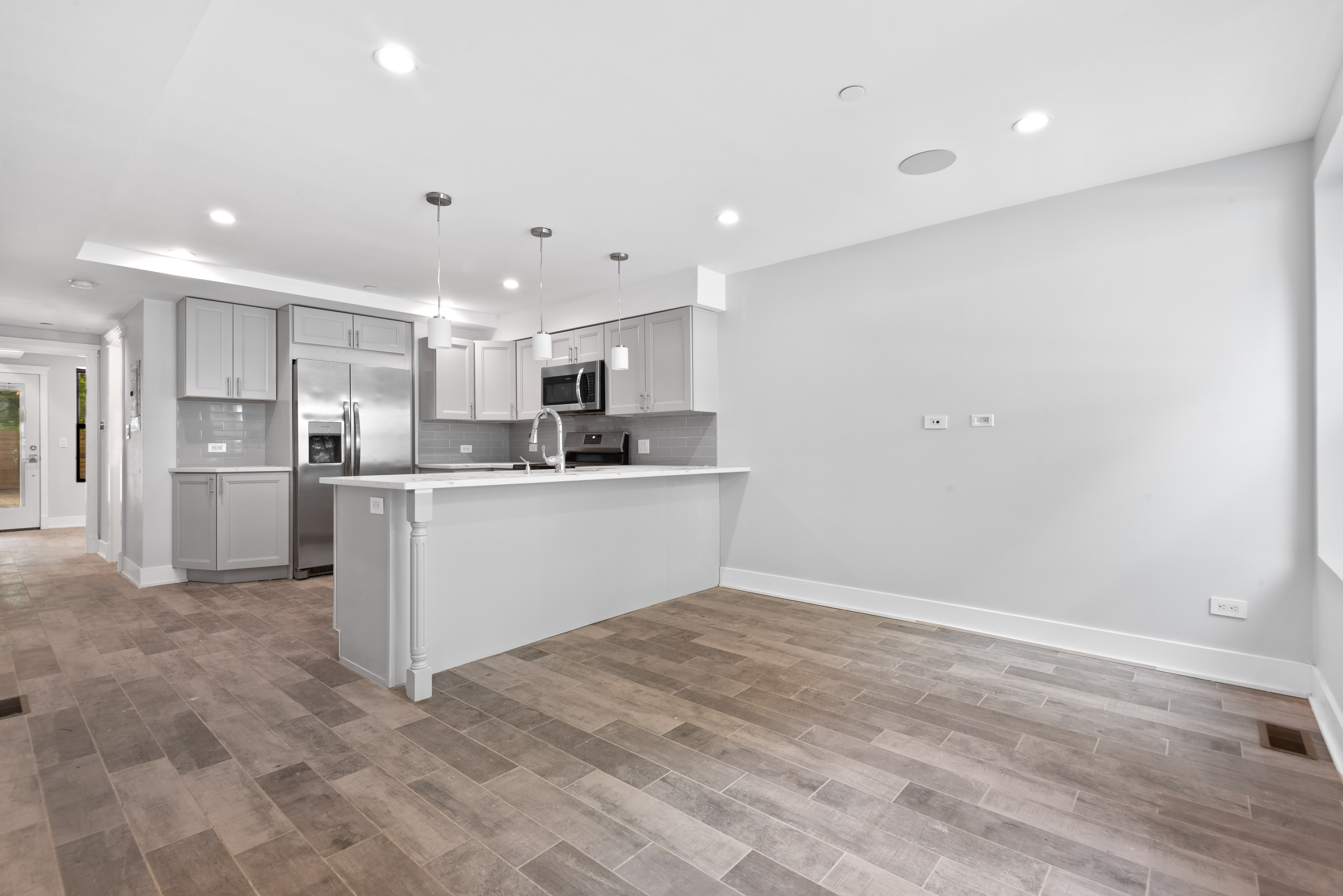 a kitchen with a refrigerator and a sink