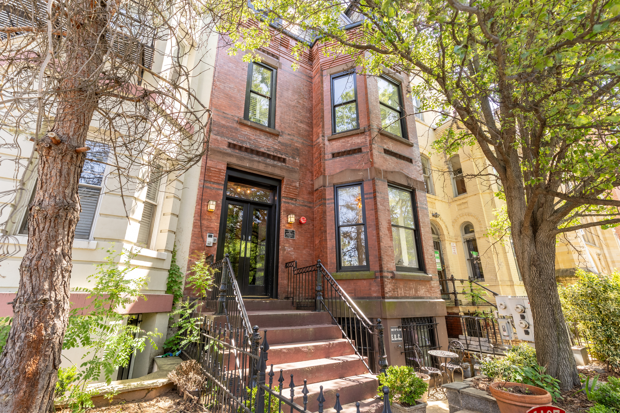 a front view of a multi story residential apartment building with a yard