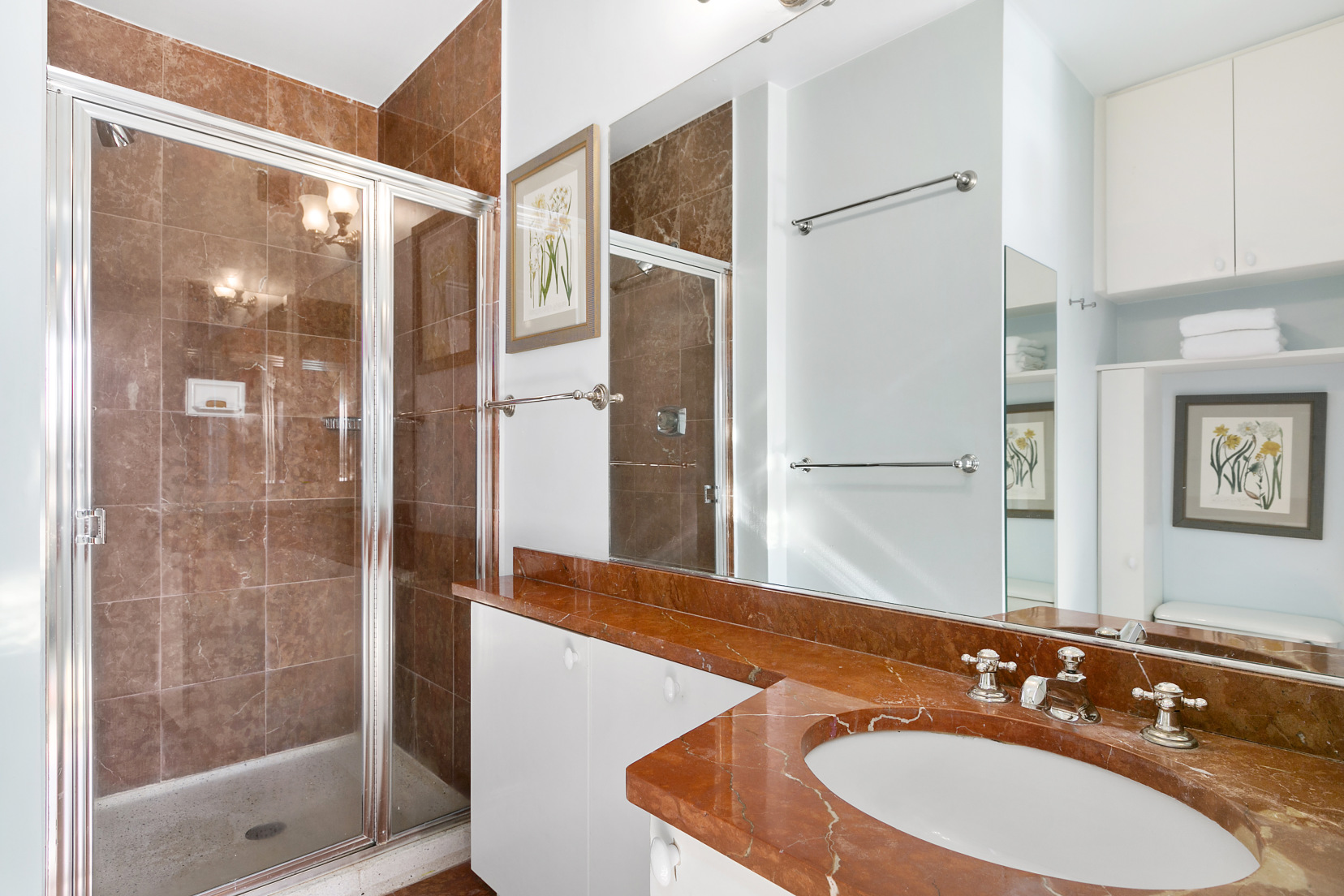 130 West 79th Street, Unit 17A Manhattan, NY 10024 - Photo 8 of 15 a bathroom with a sink and a mirror