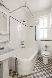 a white bath tub sitting next to a white sink