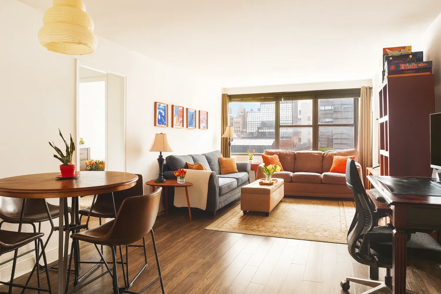 a living room with furniture wooden floor and a table