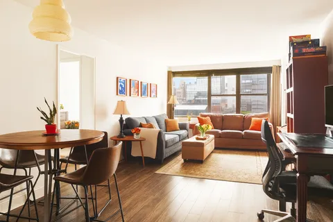 a living room with furniture wooden floor and a table