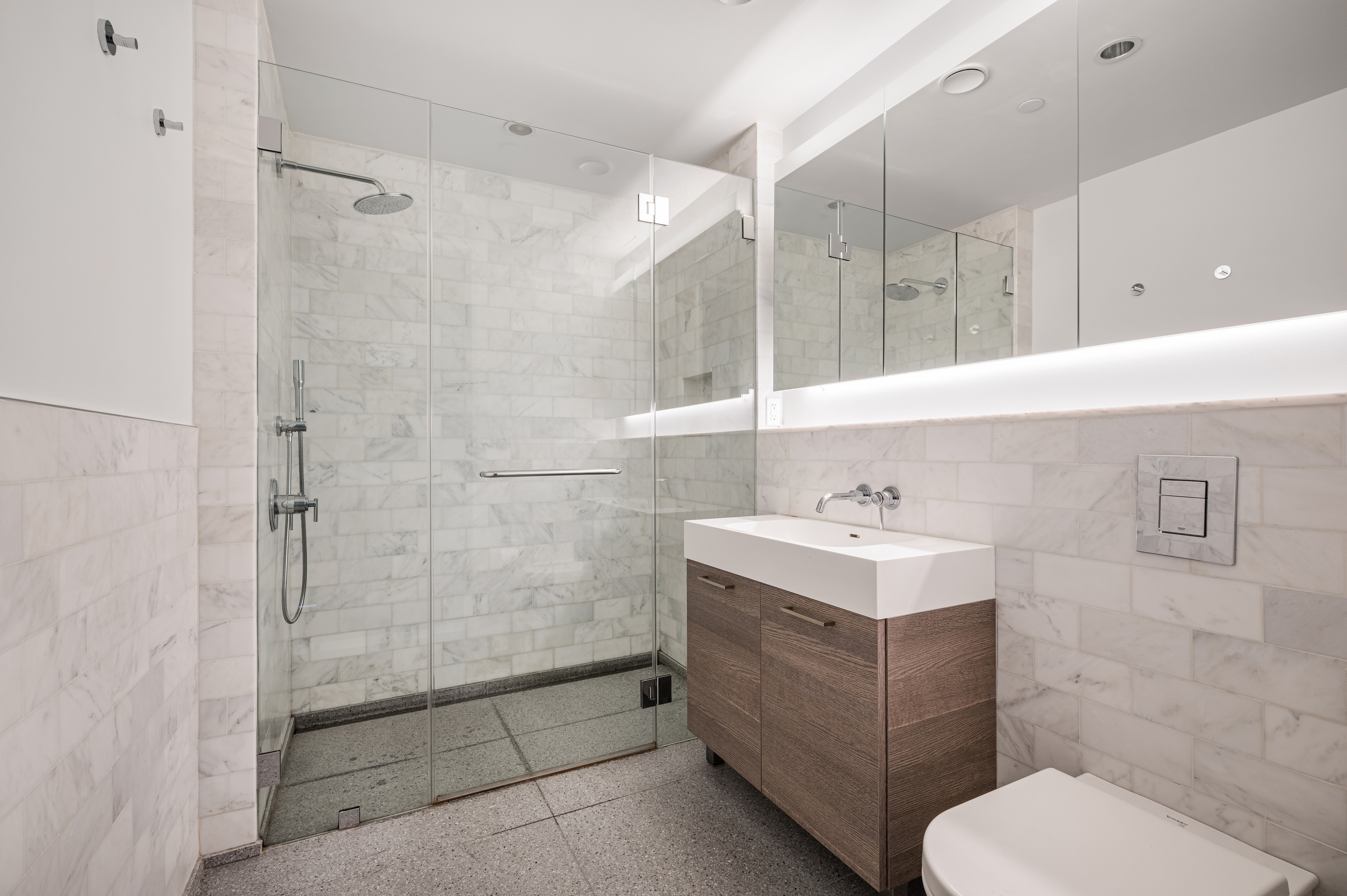591 3rd Avenue, Unit 9C Manhattan, NY 10016 - Photo 5 of 13 a bathroom with a sink toilet and shower