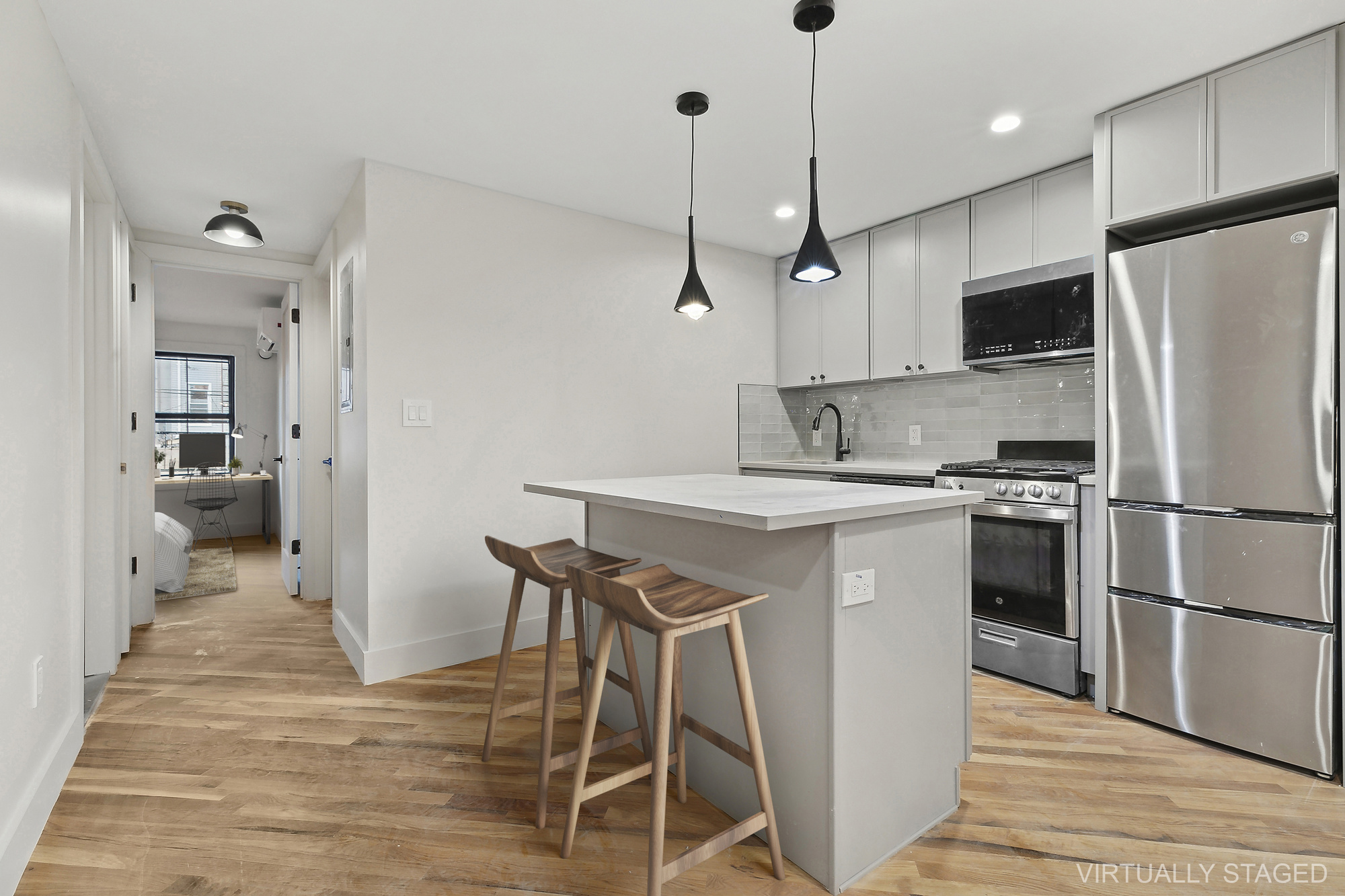 1265 Madison Street, Unit 1 Brooklyn, NY 11221 - Photo 3 of 11 a kitchen with kitchen island a counter space a sink appliances and cabinets