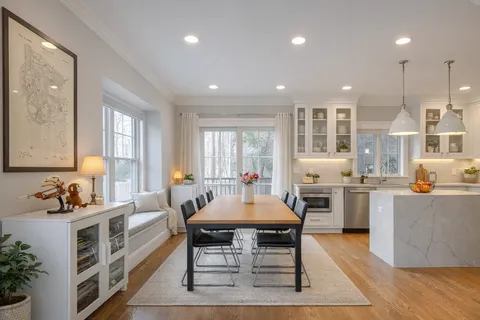 a large kitchen with a table and chairs in it