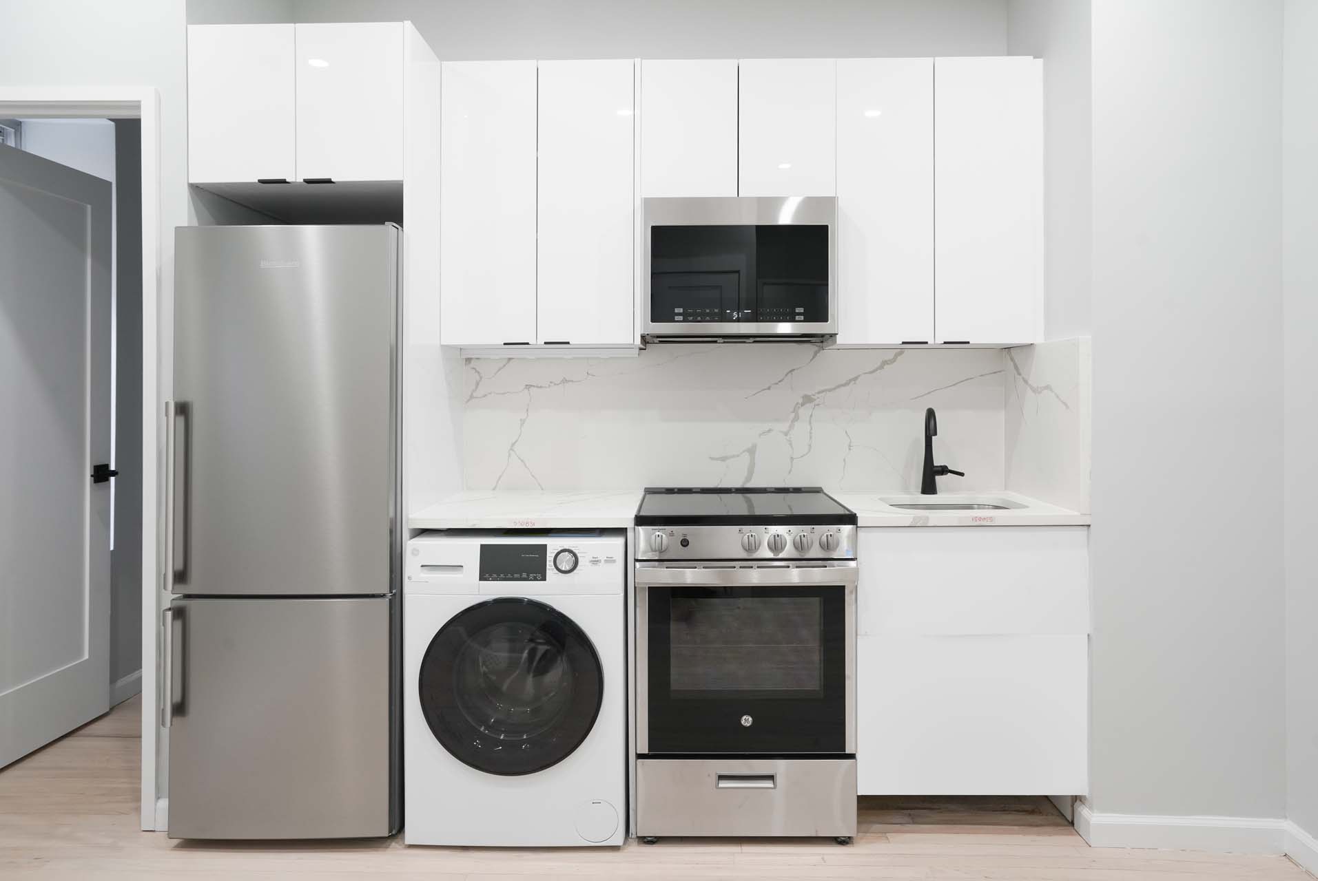 210 West 10th Street, Unit 1C Manhattan, NY 10014 - Photo 3 of 6 a kitchen with a stove and a microwave