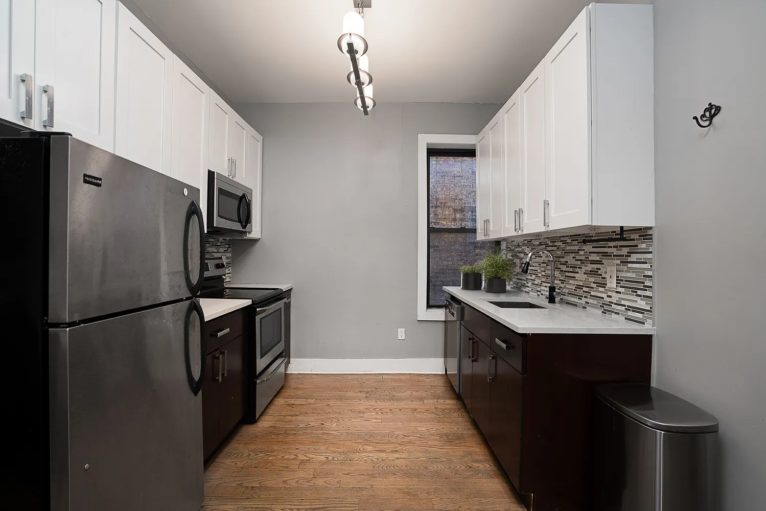 a kitchen with stainless steel appliances granite countertop a refrigerator a stove and a sink