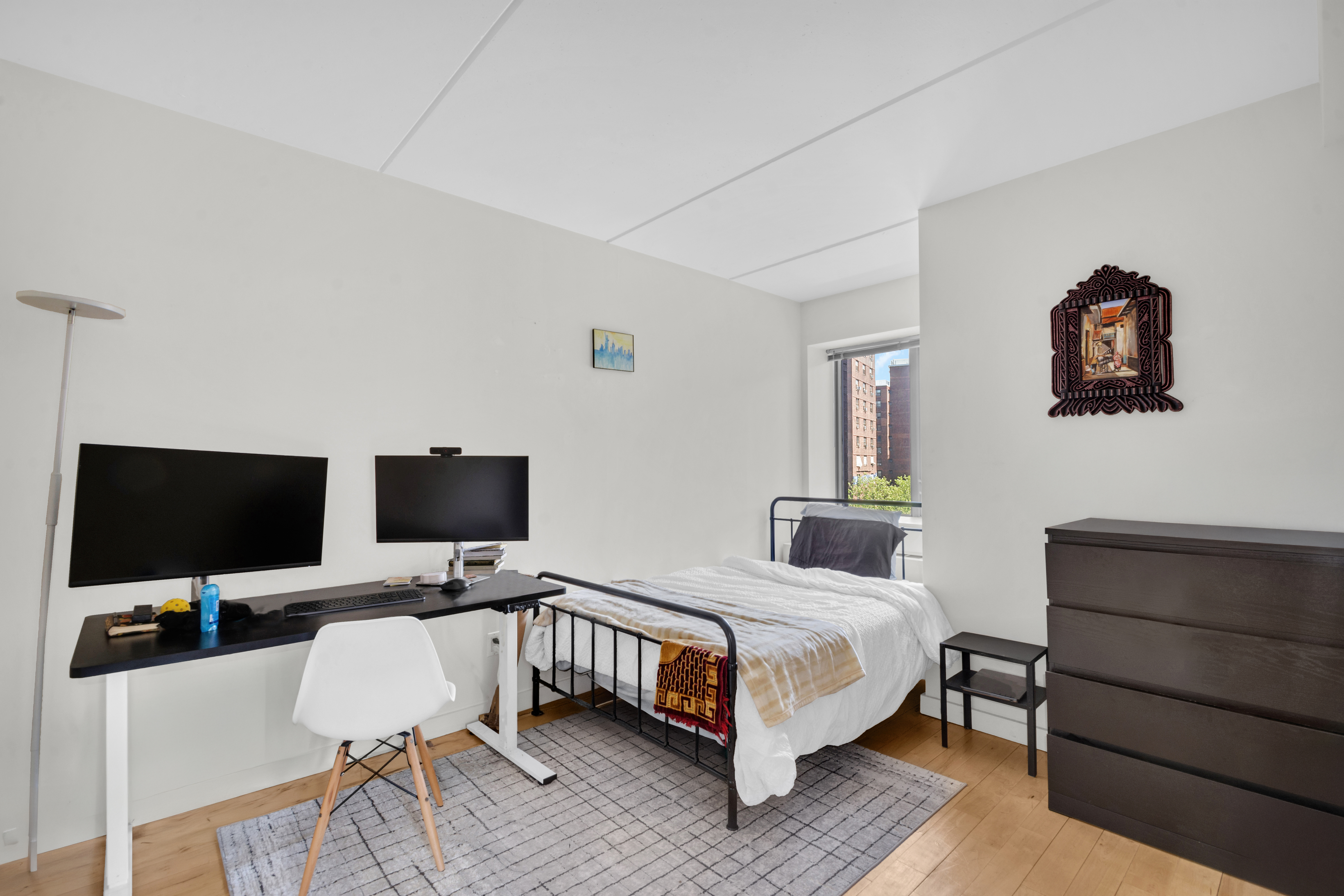 1810 3rd Avenue, Unit A7D Manhattan, NY 10029 - Photo 5 of 13 a bedroom with a bed and a flat screen tv