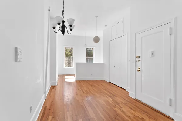 a view of a room with wooden floor