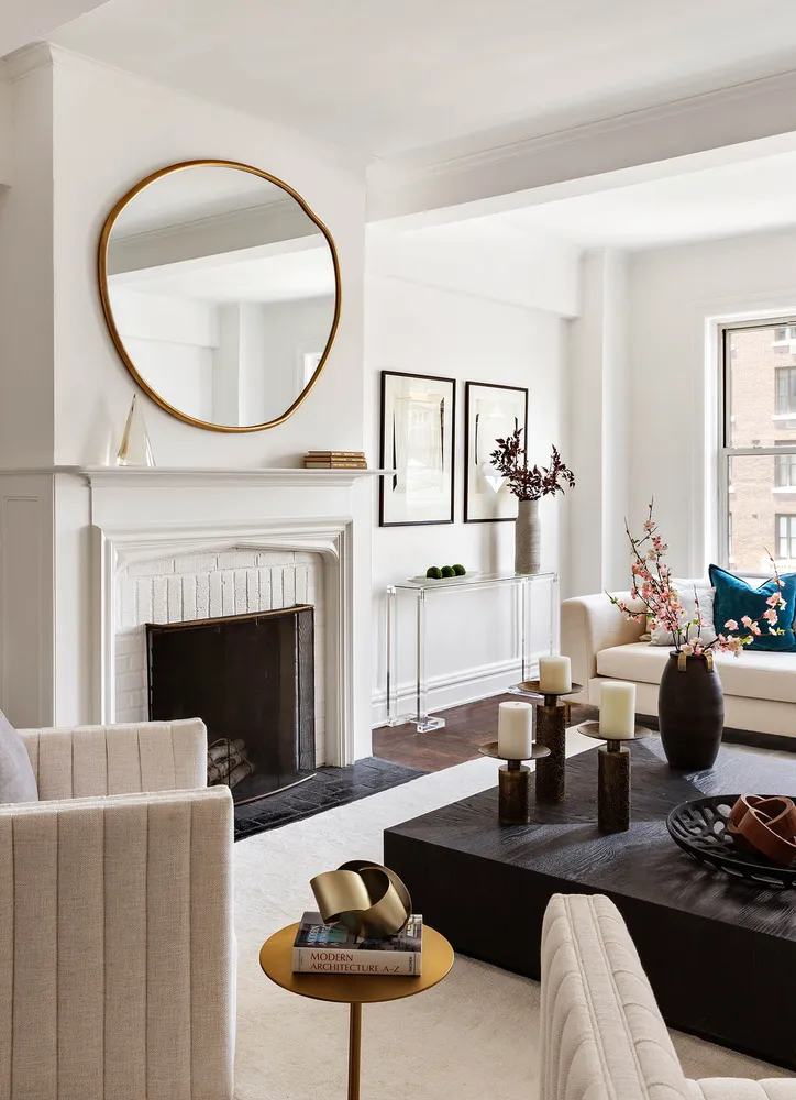 a living room with furniture a fireplace and a large window