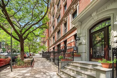 a view of a building with a bench in patio