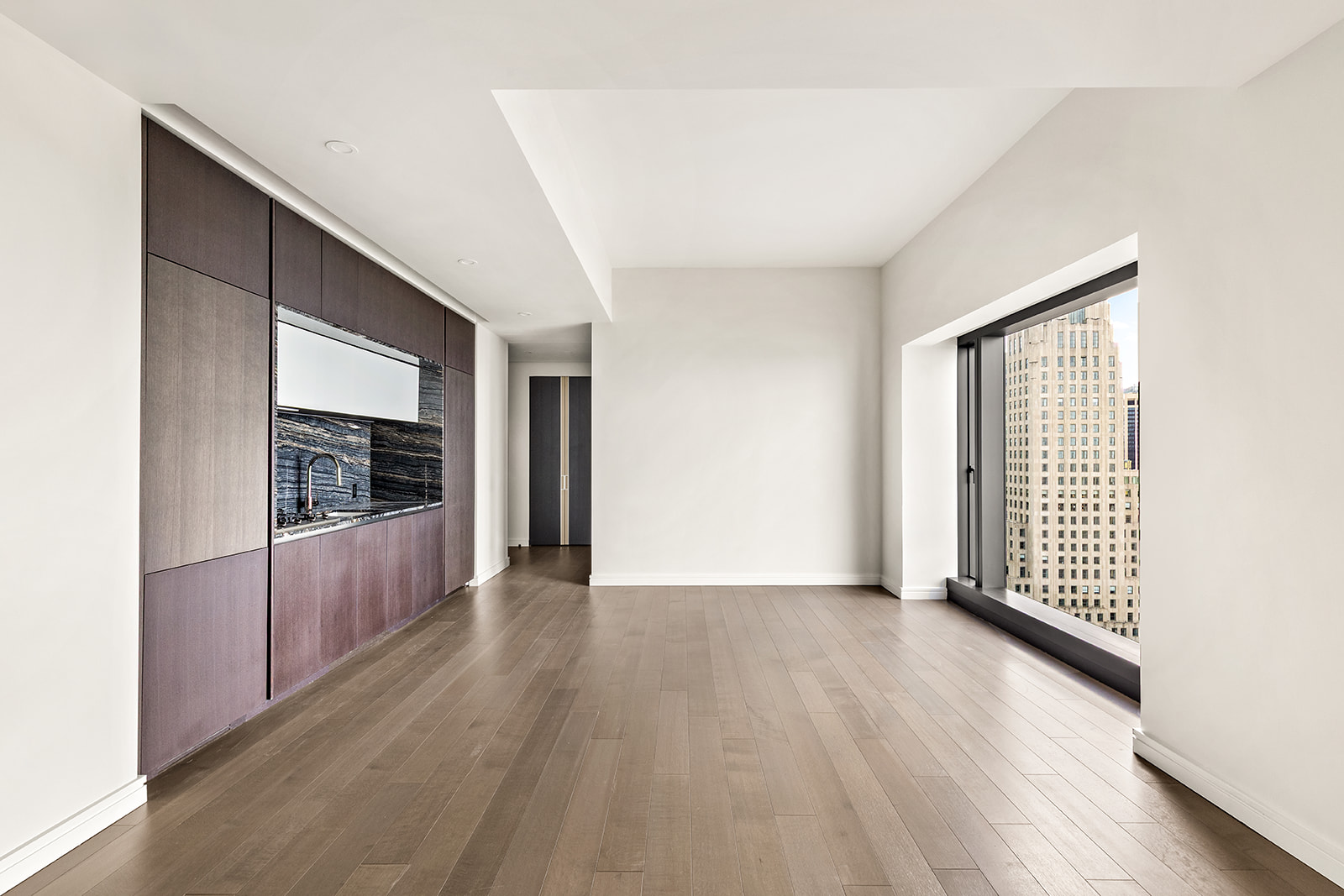 125 Greenwich Street, Unit 61C Manhattan, NY 10006 - Photo 4 of 16 a view of an empty room with a window and wooden floor