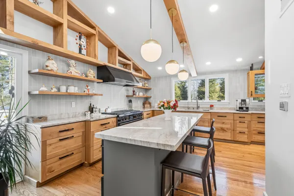 a kitchen with stainless steel appliances granite countertop a stove and a cabinets